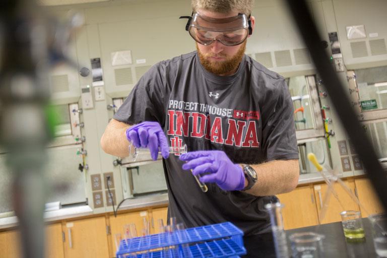 A student measures chemicals.