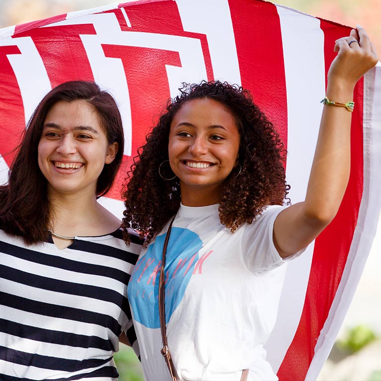 Students hold up an IU banner.